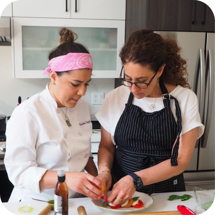 Two cooks plating a dish