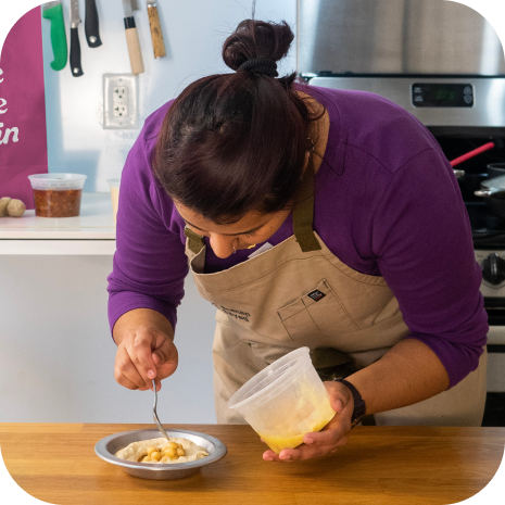 A cook plating a dish